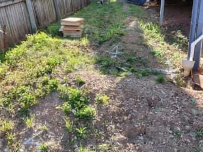 Before concrete sleeper retaining walls and fencing on sloped property